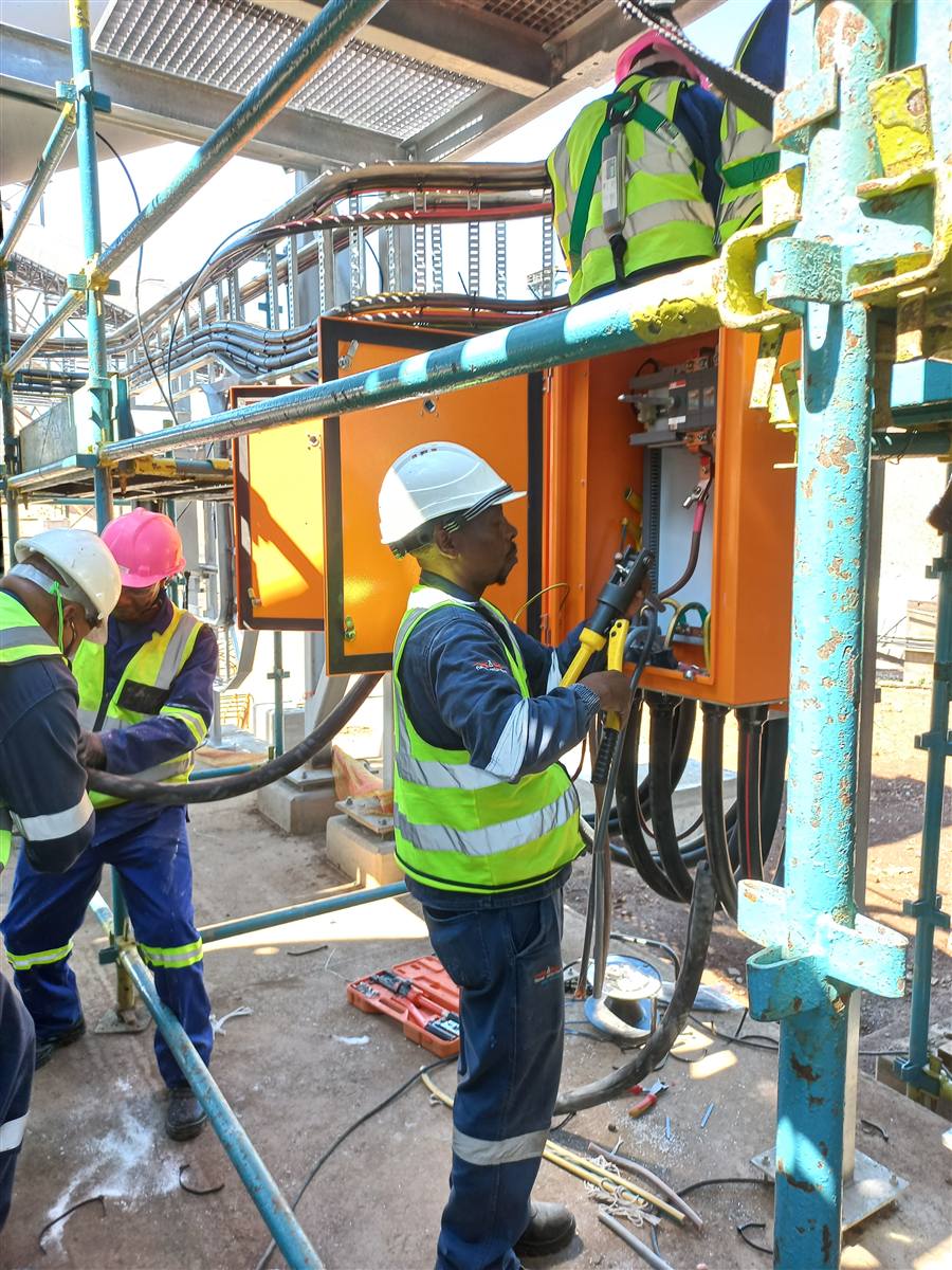 ICA technicians terminating cables in an electrical enclosure at a plant site